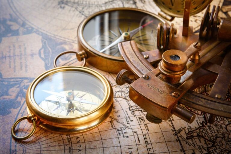 Old compass, astrolabe on vintage map. Retro stale. Very shallow focus.