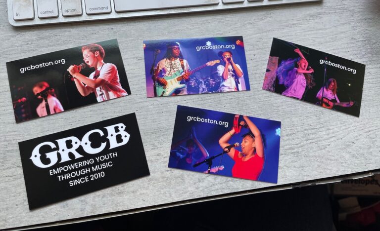 A set of GRCB promotional cards on a desk with a computer keyboard