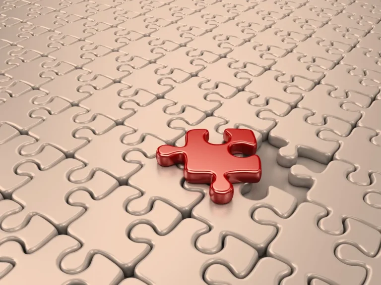 A golden jigsaw puzzle with a single white piece