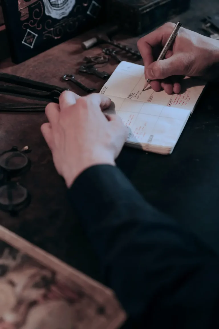 Hands writing in a paper calendar